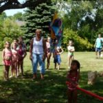 Kids taking swings at the piñata at the annual picnic on the island